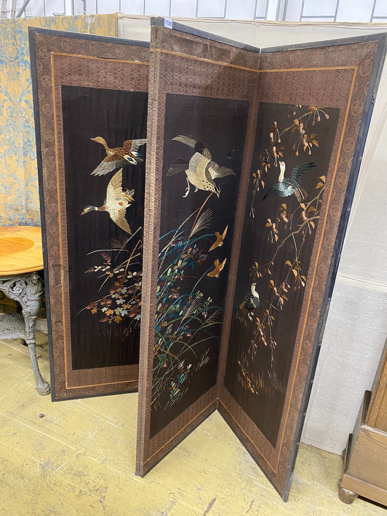 A Chinese silk thread embroidered four fold dressing screen, each panel width 56cm, height 170cm